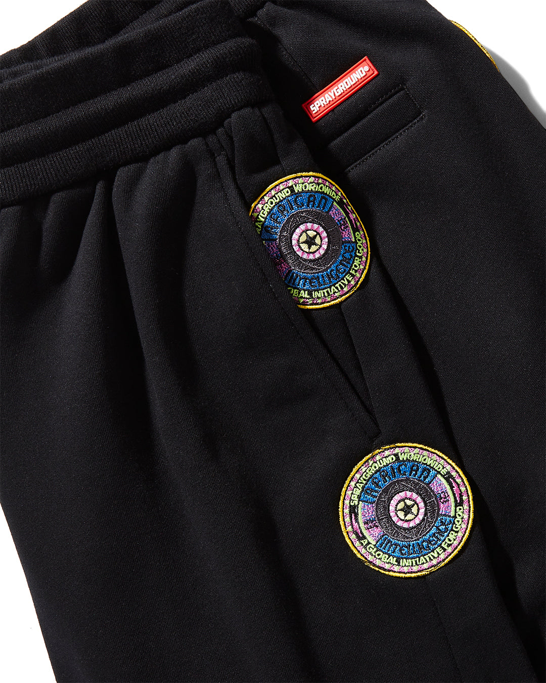Close-up of the red drawstring tips on the joggers, highlighting the collabs unique design element.