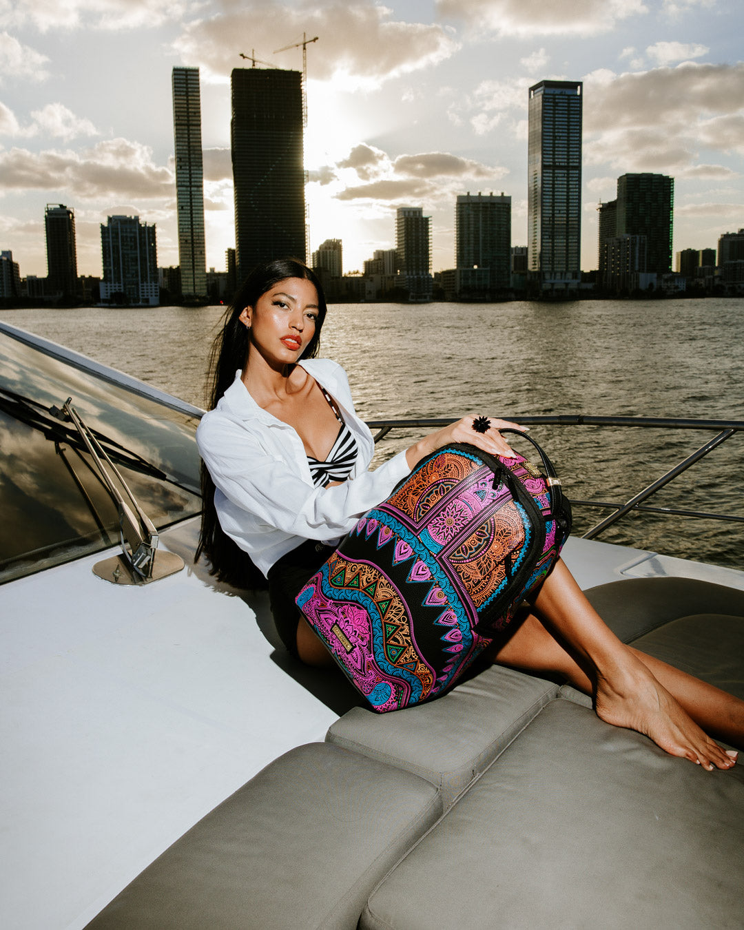 Front view of the Sprayground backpack showing zippered compartments and bold A.I. art design.