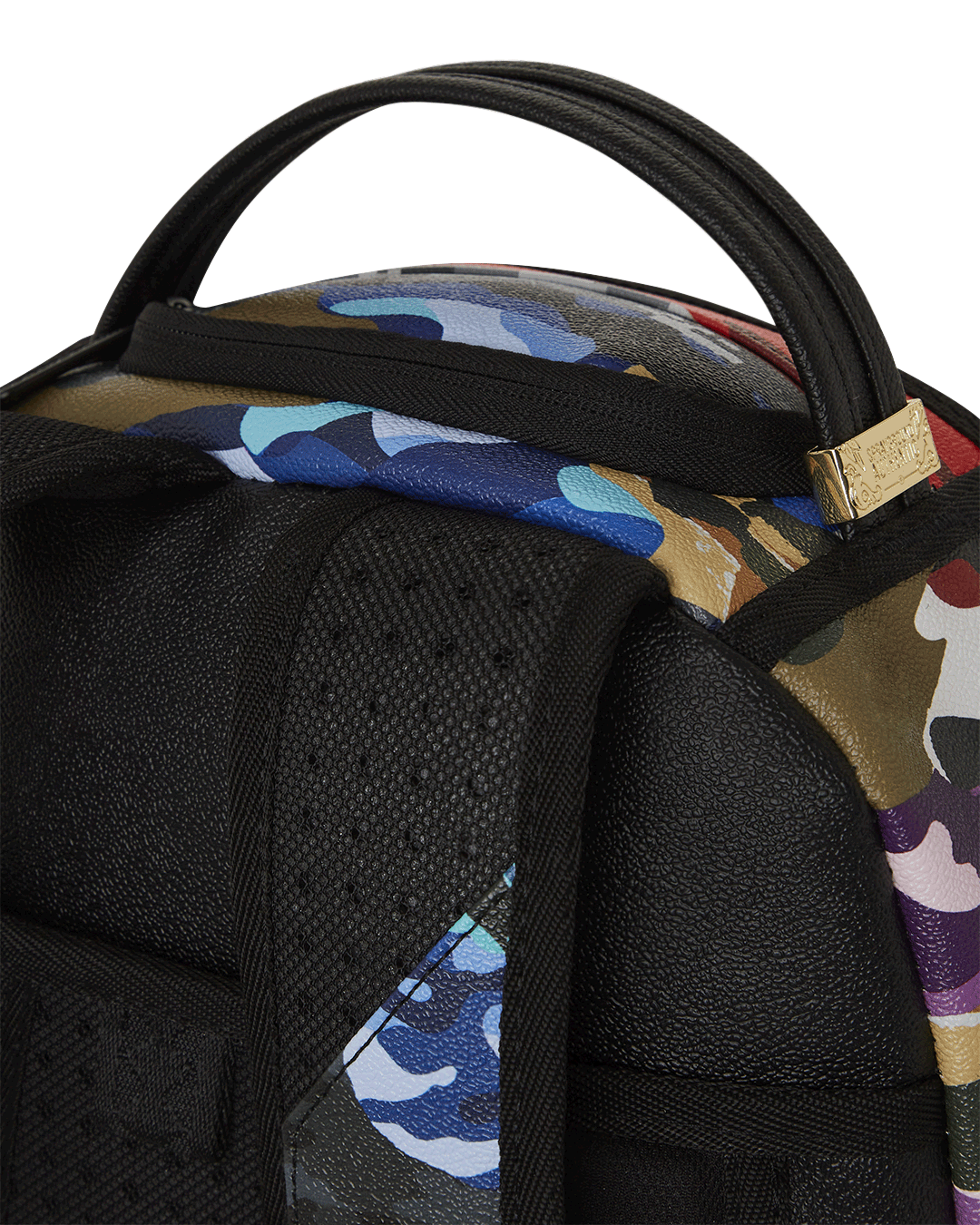 Close-up of gold zippers and tactical pockets on camo backpack