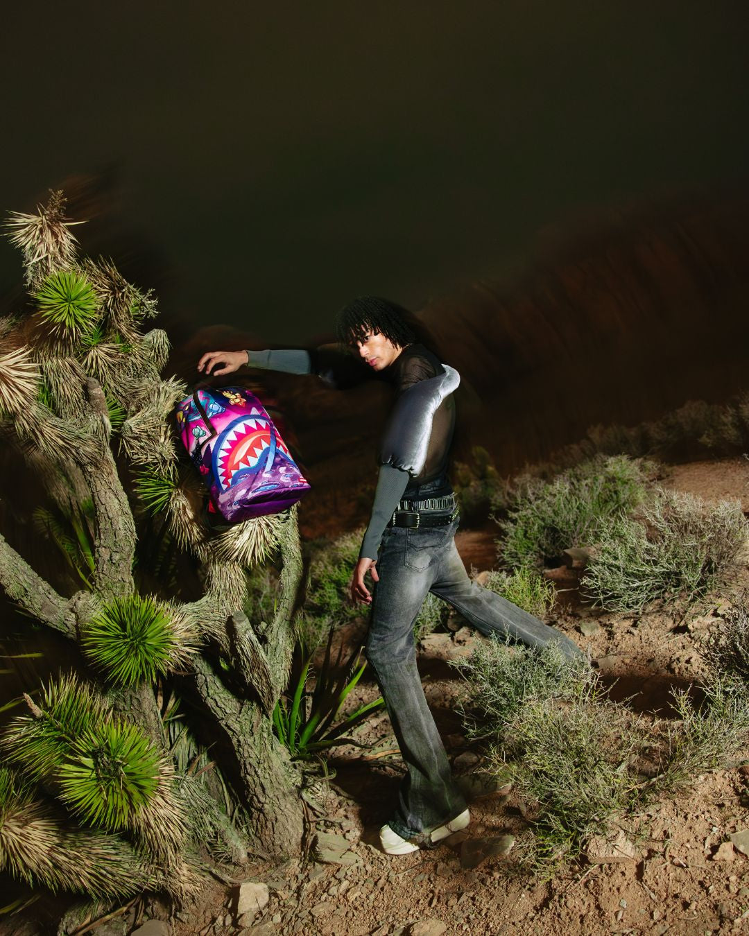 Astro Crew travel backpack displayed against a scenic backdrop, showcasing its stylish design.