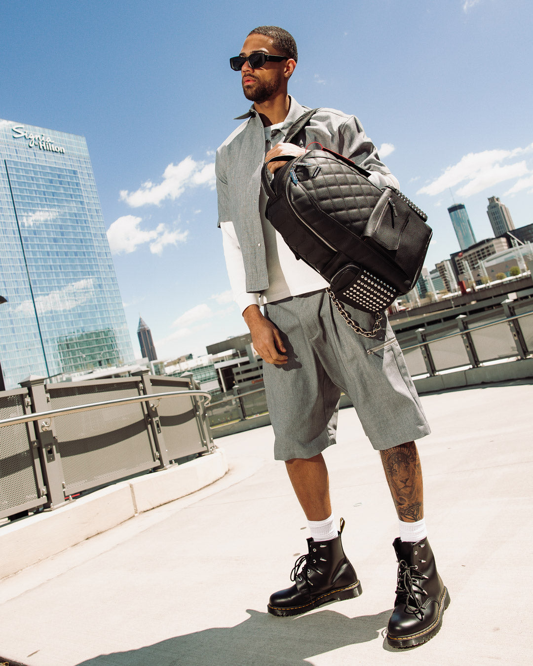 Side view of backpack open to reveal laptop compartment and organizational pockets