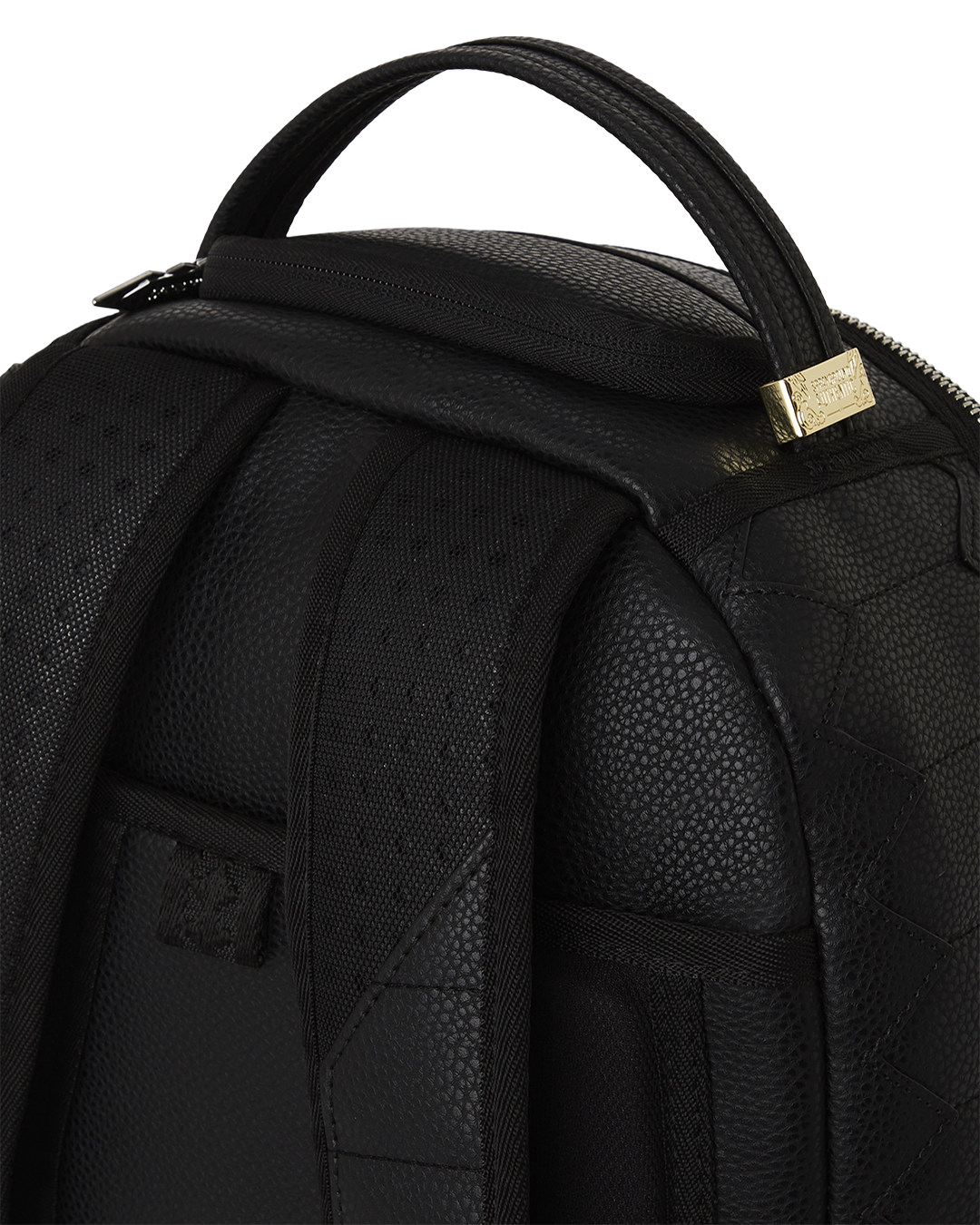 Close-up of Strada mens leather backpack showcasing quilted texture and stud details