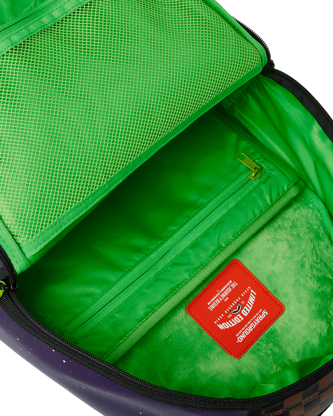 Rick and Morty faux leather backpack standing upright near carry-on luggage