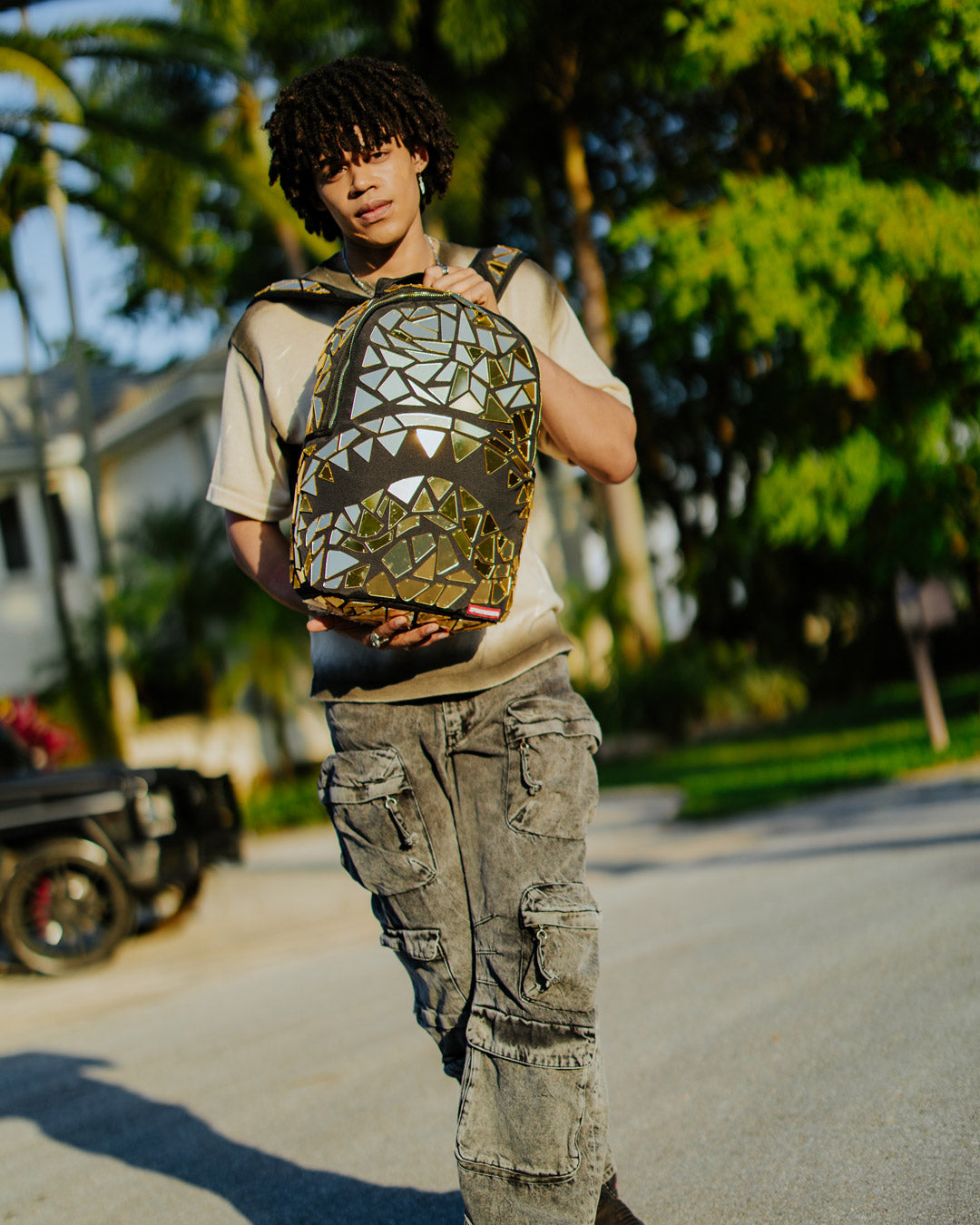 Front view of handmade mirror shark burst backpack highlighting gold acrylic tile detail