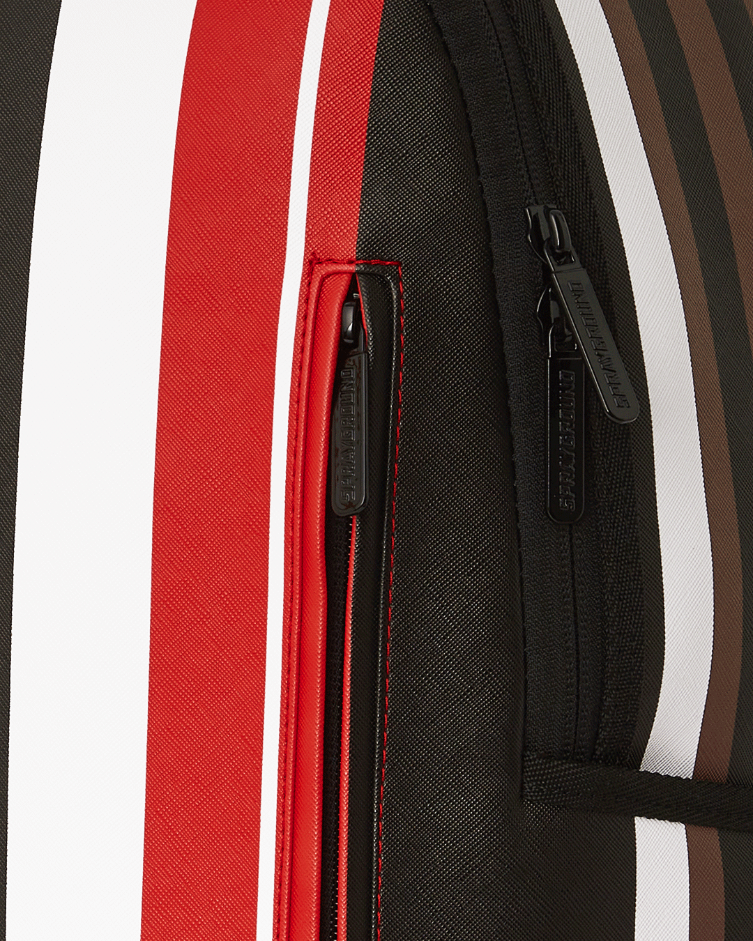 Close-up of Sprayground backpack pink with gold zippers and shark design