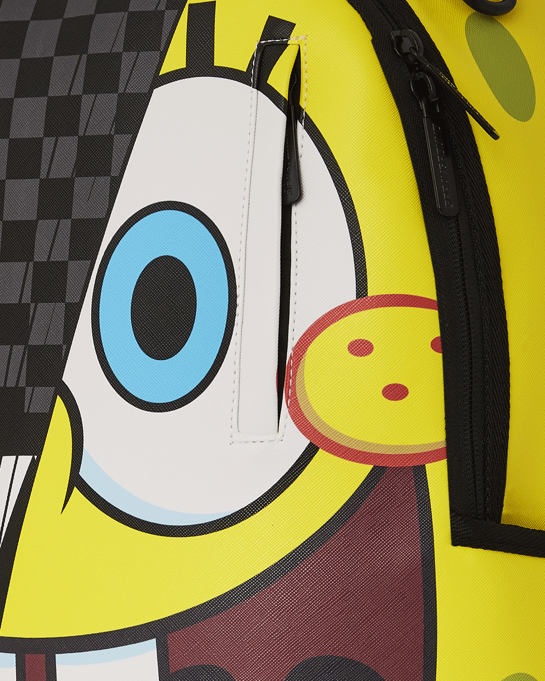 Close-up of the backpacks faux leather material and gold zippers