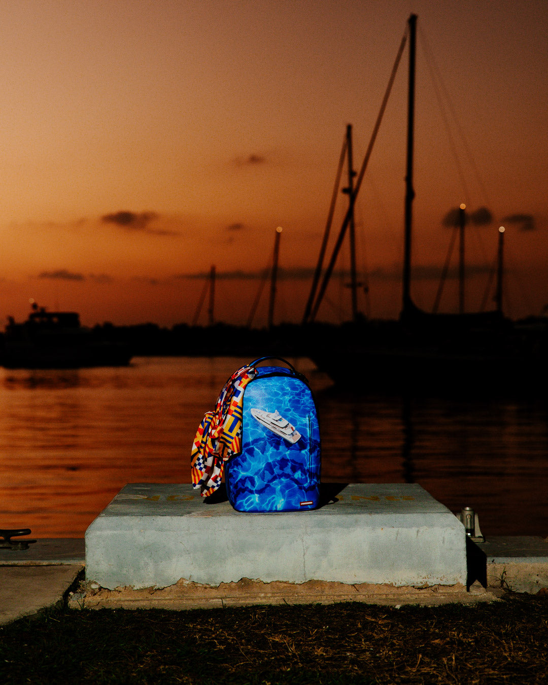 Nautica backpack worn over shoulder, showcasing removable scarf detail