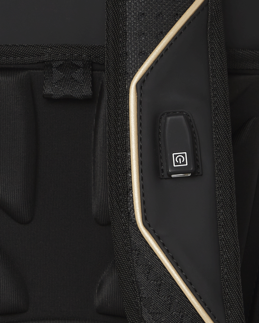 Close-up of the backpacks USB charging port and adjustable straps