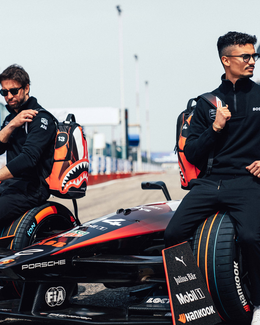 Formula-E travel backpack shown connected to suitcase, perfect for airport transit