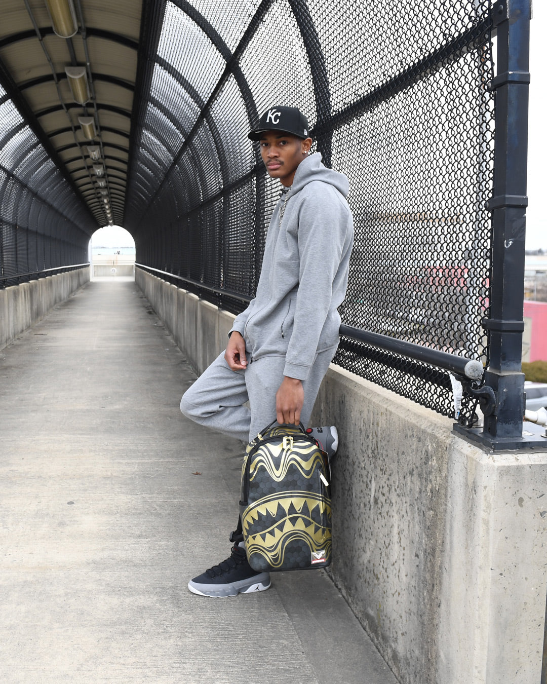 Peak Design travel backpack styled with a laptop and sunglasses