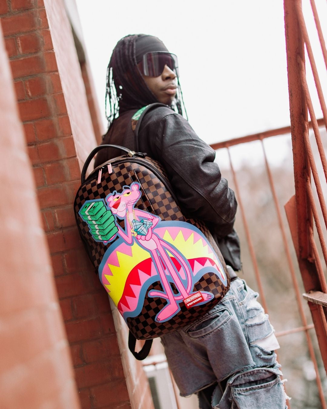 Front view of the Pink Panther faux leather backpack with gold zippers.