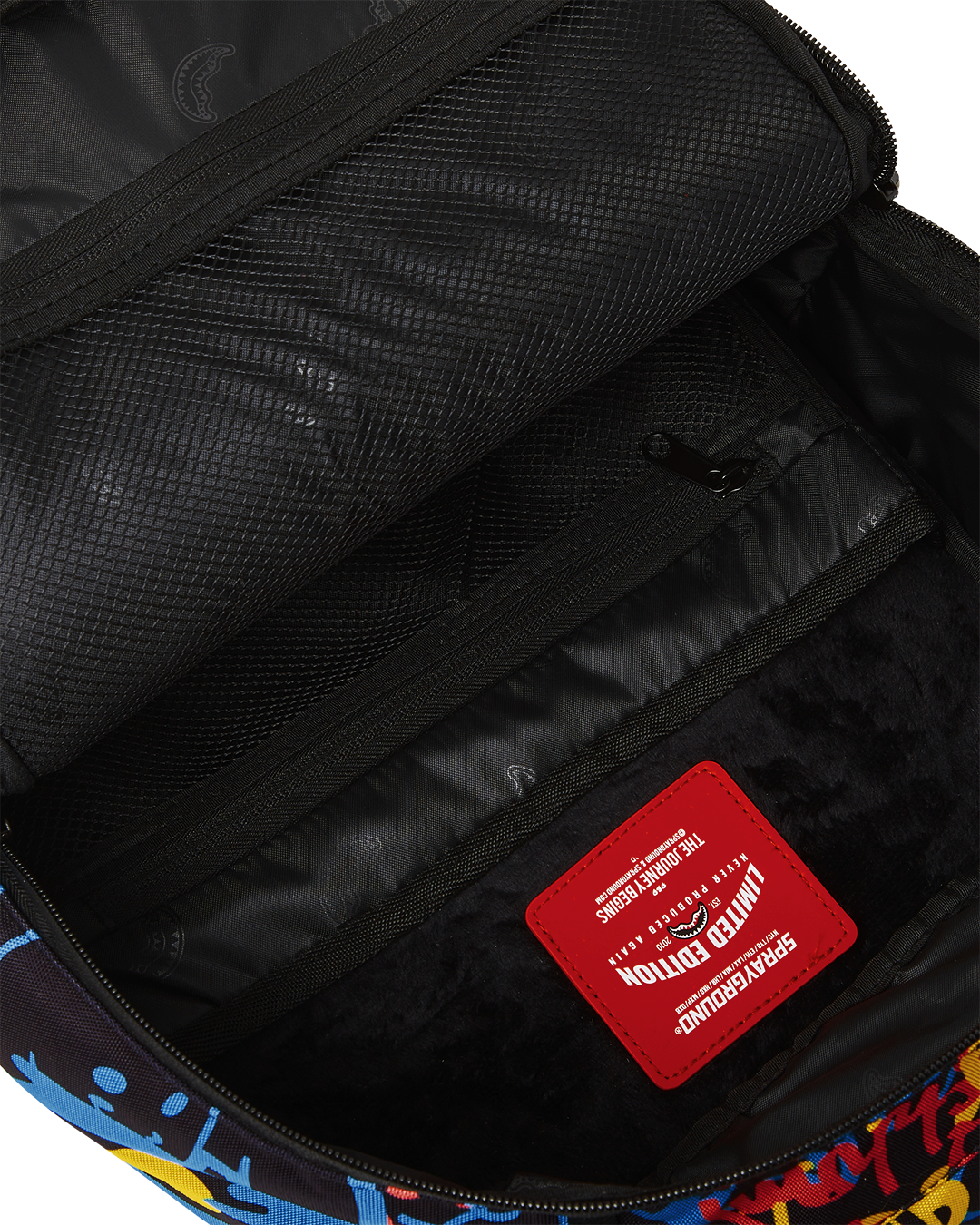 Side view of Sprayground backpack showing Smurfs art and neon accents