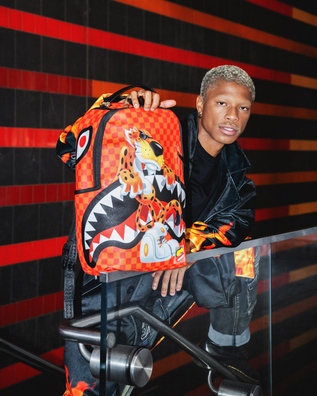 Front view of the Cheetos Chester Crunch faux leather backpack showing spacious compartments