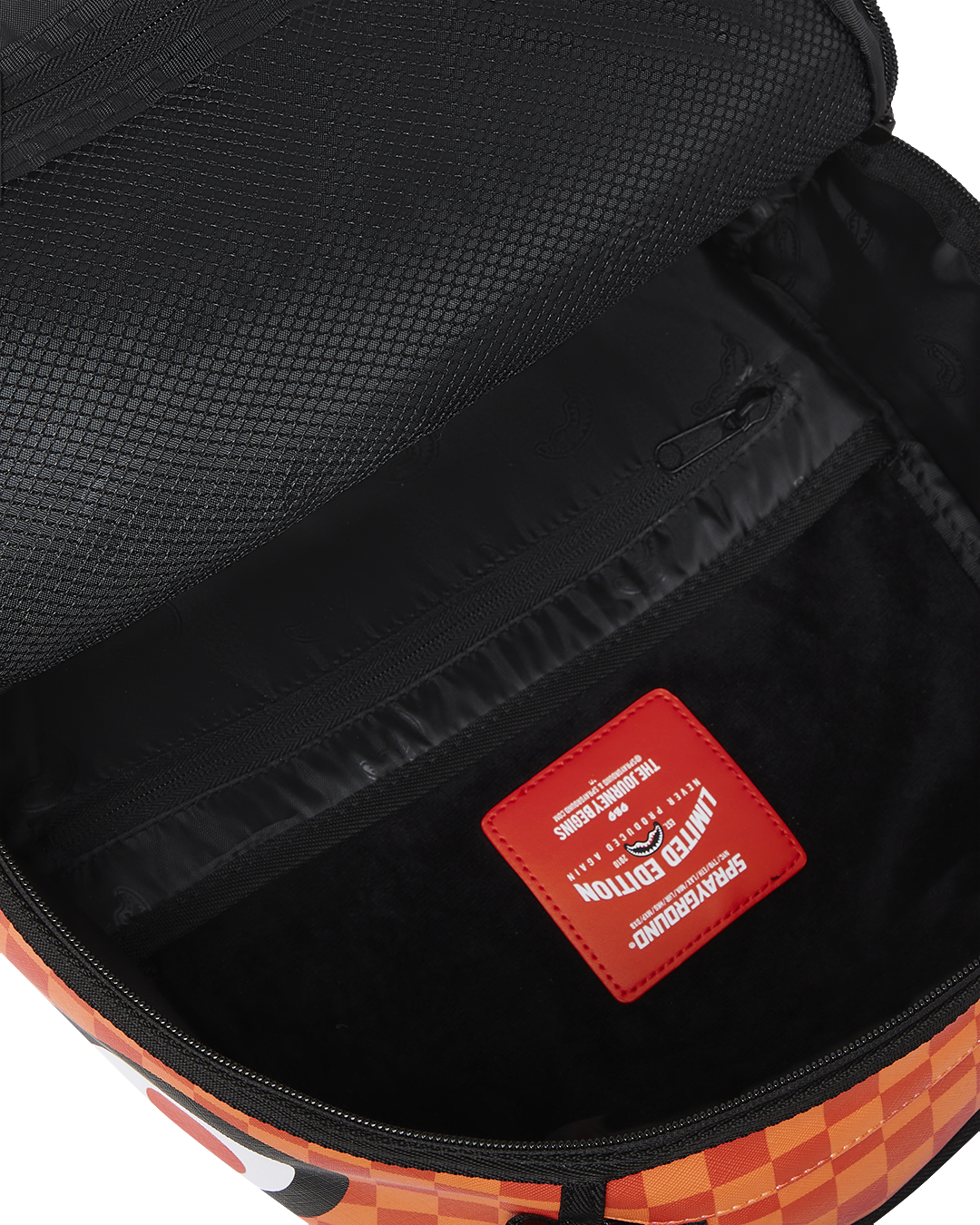 Interior shot of the faux leather backpack with velour laptop sleeve and organizer pockets