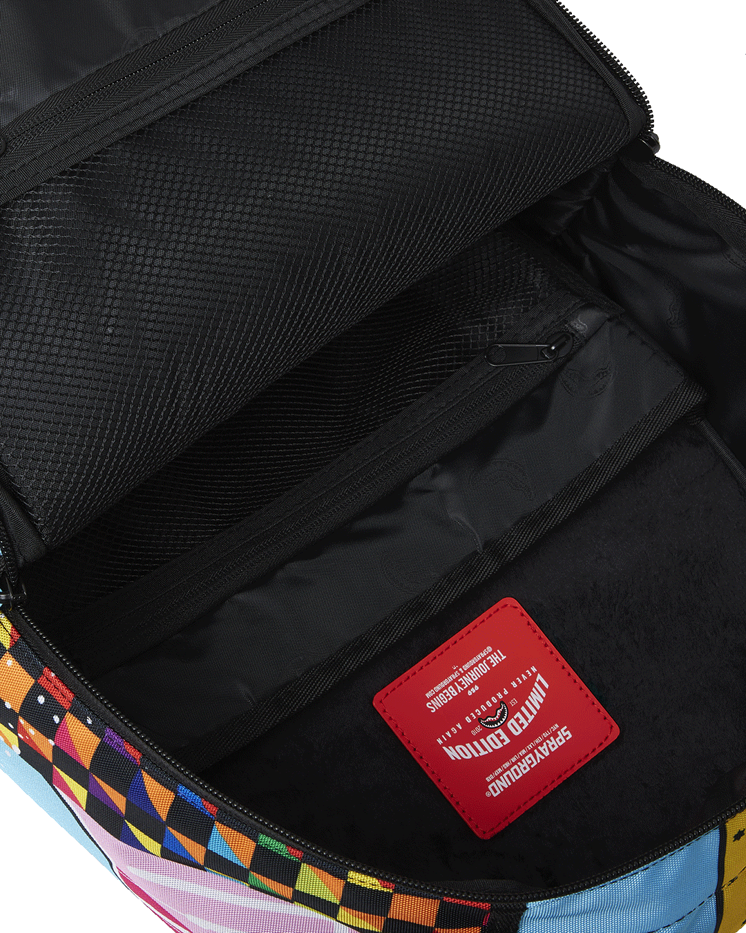 Sprayground DLXSR Collage Backpack in Pink with laptop and accessories inside
