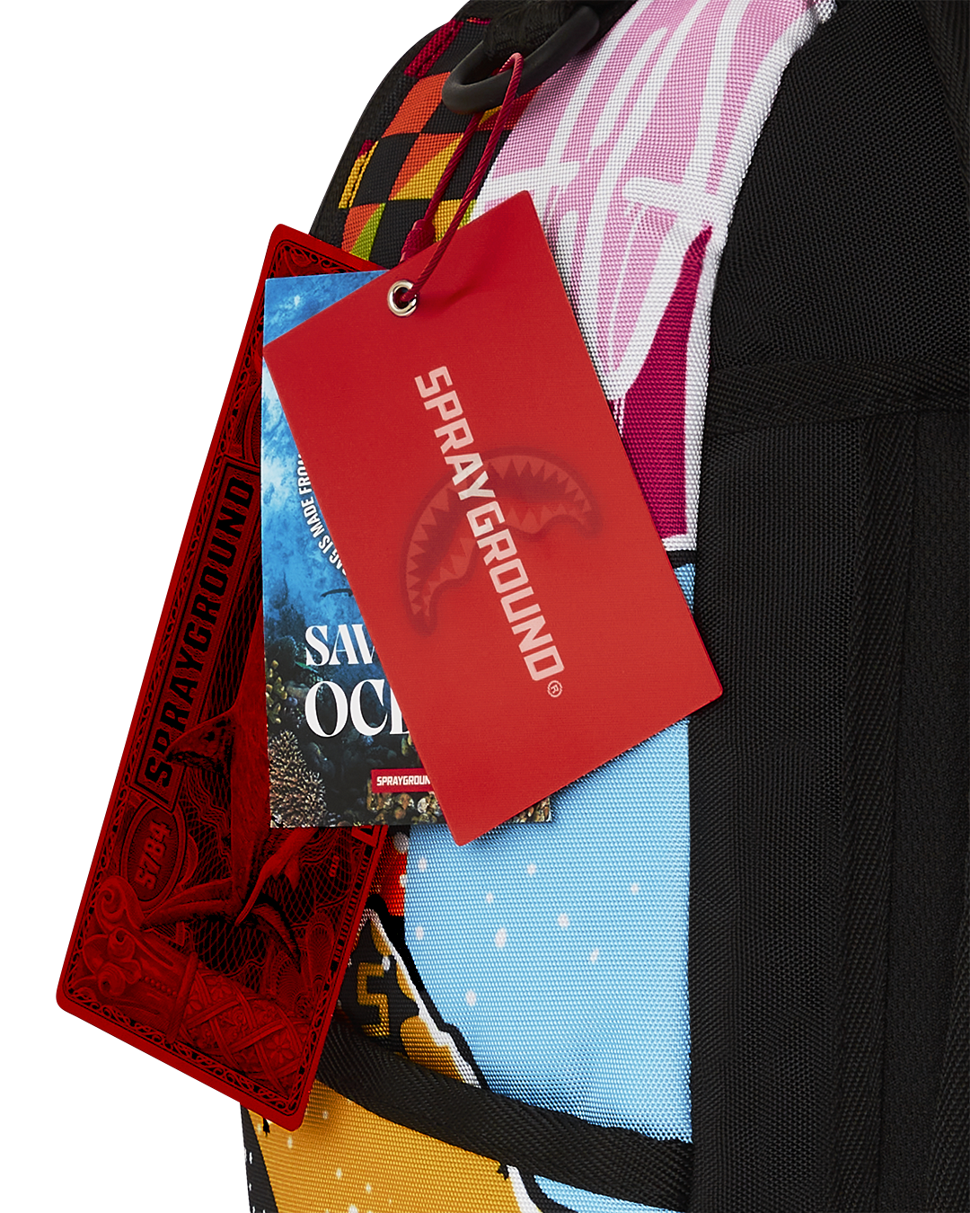 Sprayground DLXSR Collage Backpack in Pink front view with multiple pockets visible