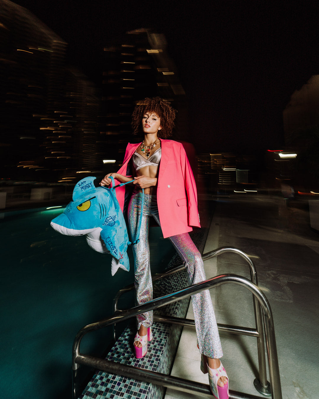 Front view of the plush shark backpack showcasing embroidered details.