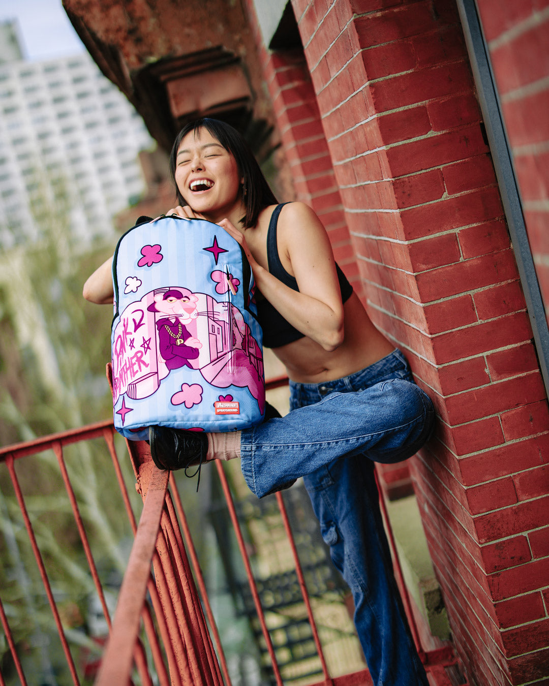 Side view of the pink backpack, highlighting the adjustable straps and organizational pockets.