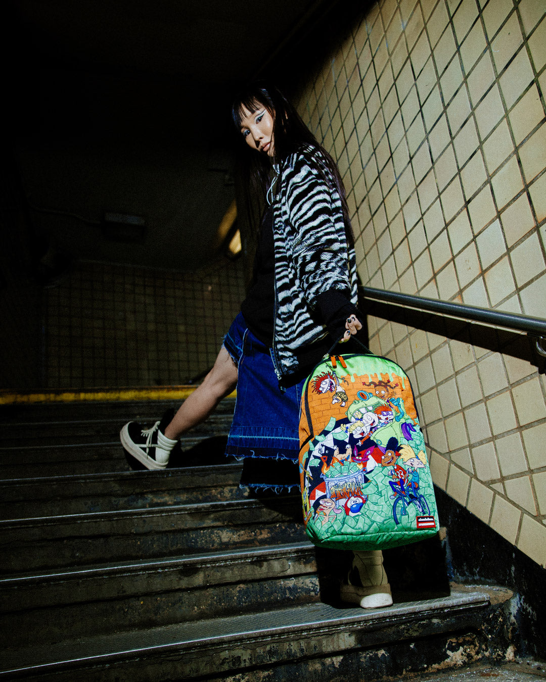 Front view of the Retro Vibes DLXSR Backpack showcasing its stylish design and gold zippers.