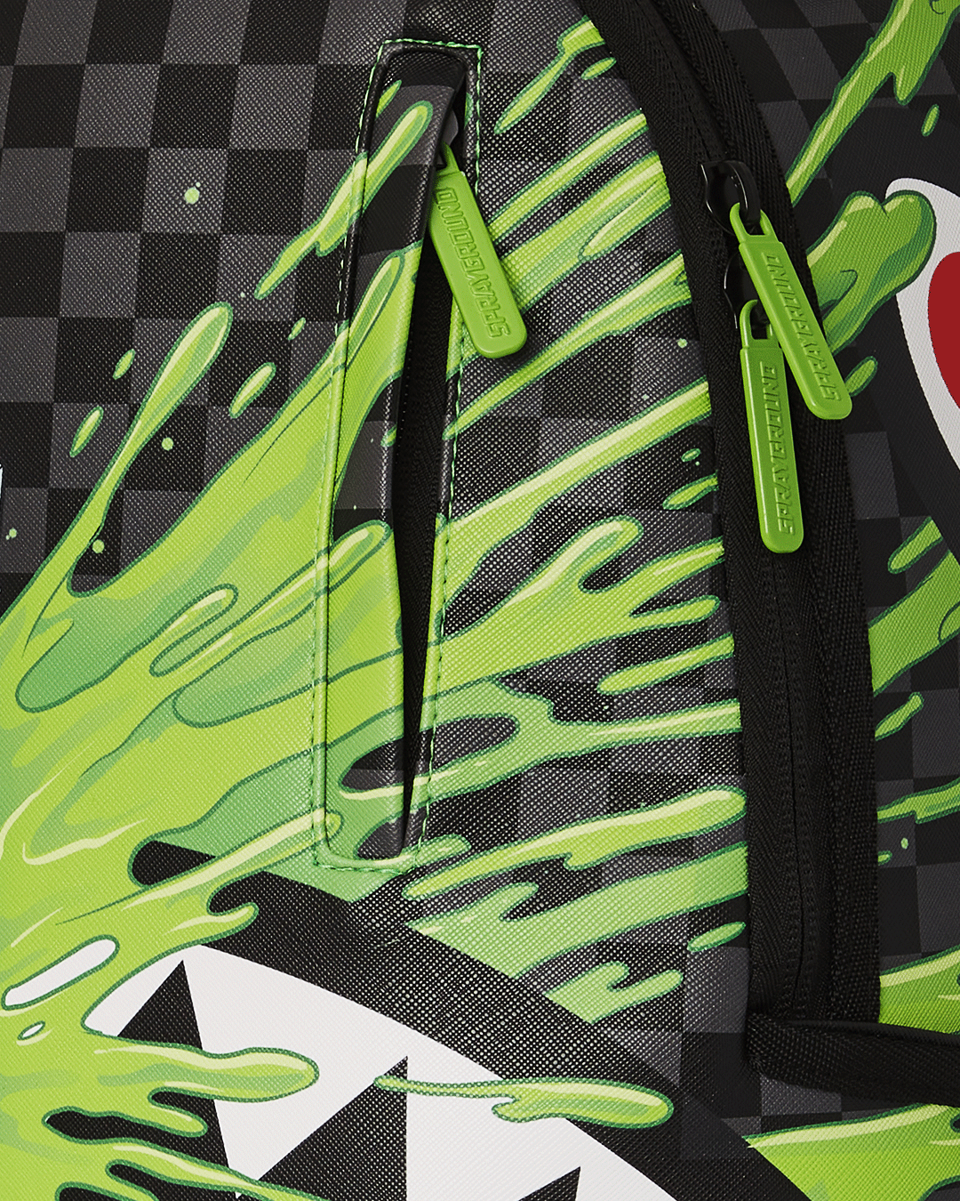 Sprayground BrainsHark laptop backpack in use, connected to carry-on luggage