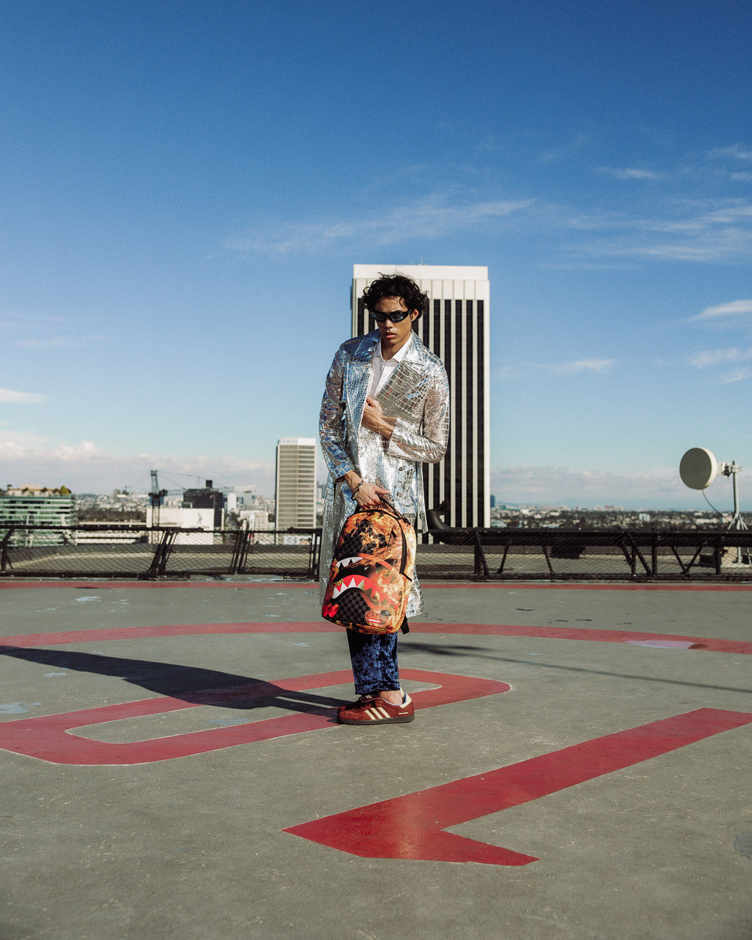 Sprayground Diablo backpack open, showing velour laptop compartment and organizer pockets.