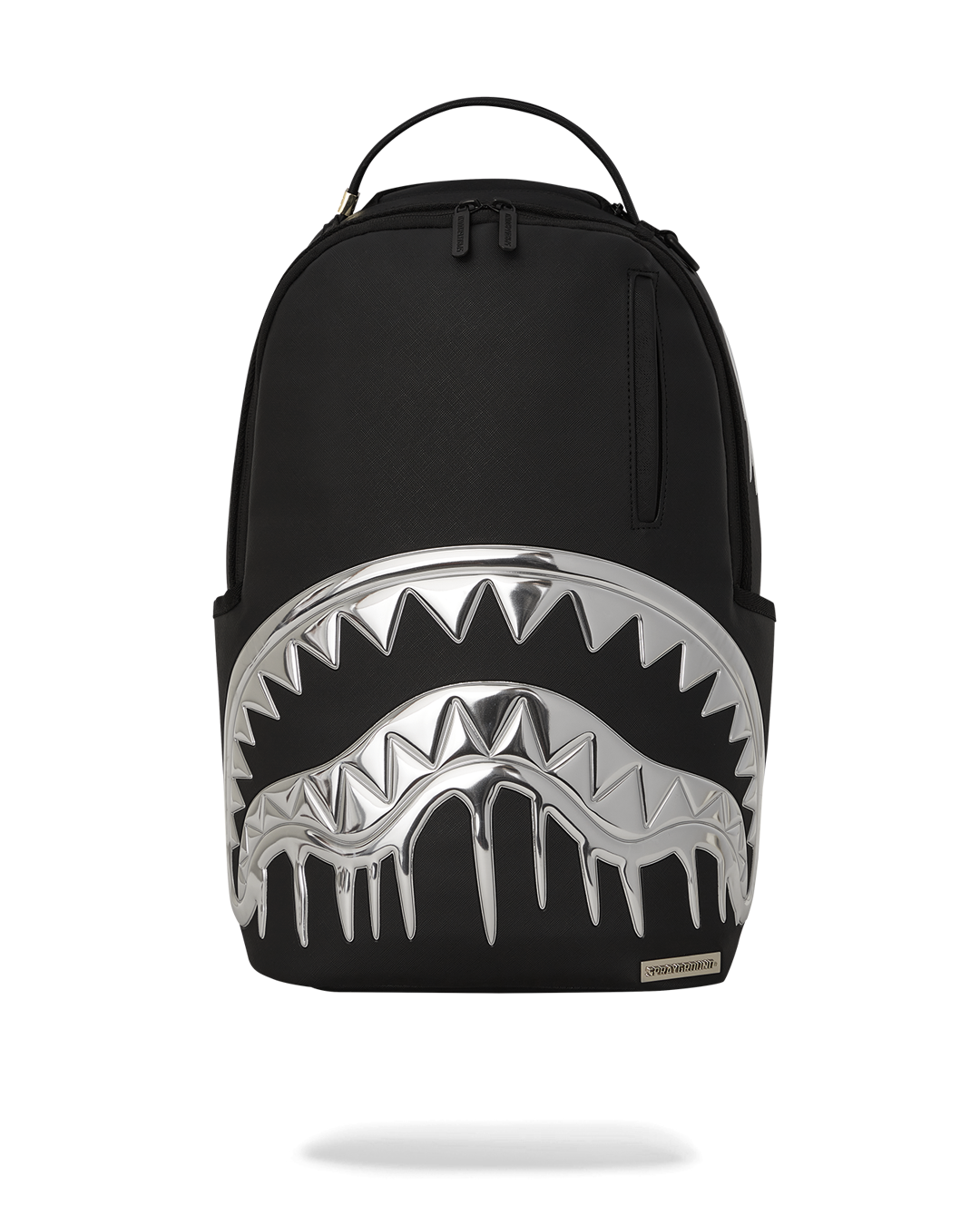 Front view of silver backpack with sharkmouth detail on sidewalk in Manhattan