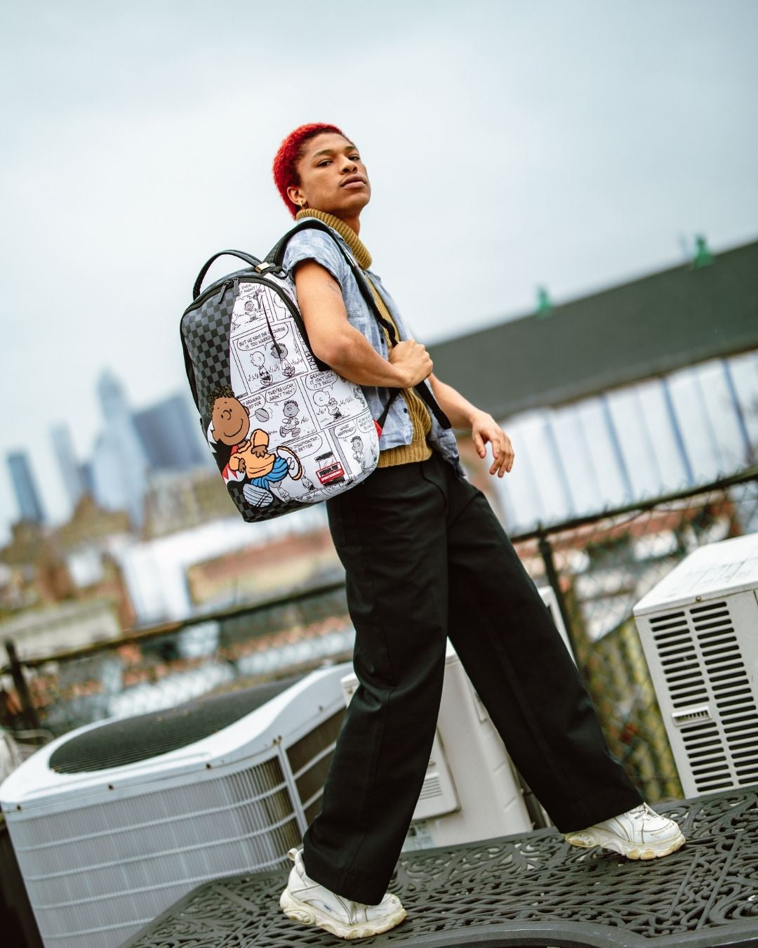 Side angle of the Franklin Sharks faux leather backpack with open pockets.