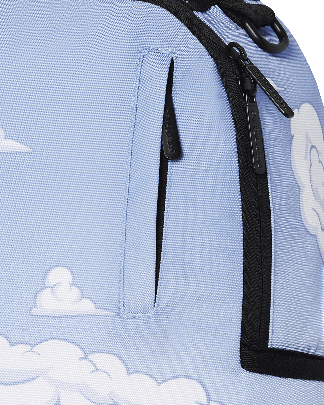 Sprayground Peanuts Fam Deluxe Backpack in use, connected to carry-on luggage