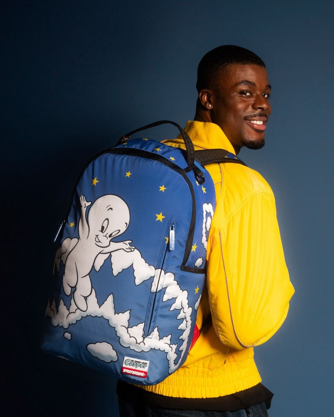 Front view of ergonomic backpack with gold zippers and laptop compartment