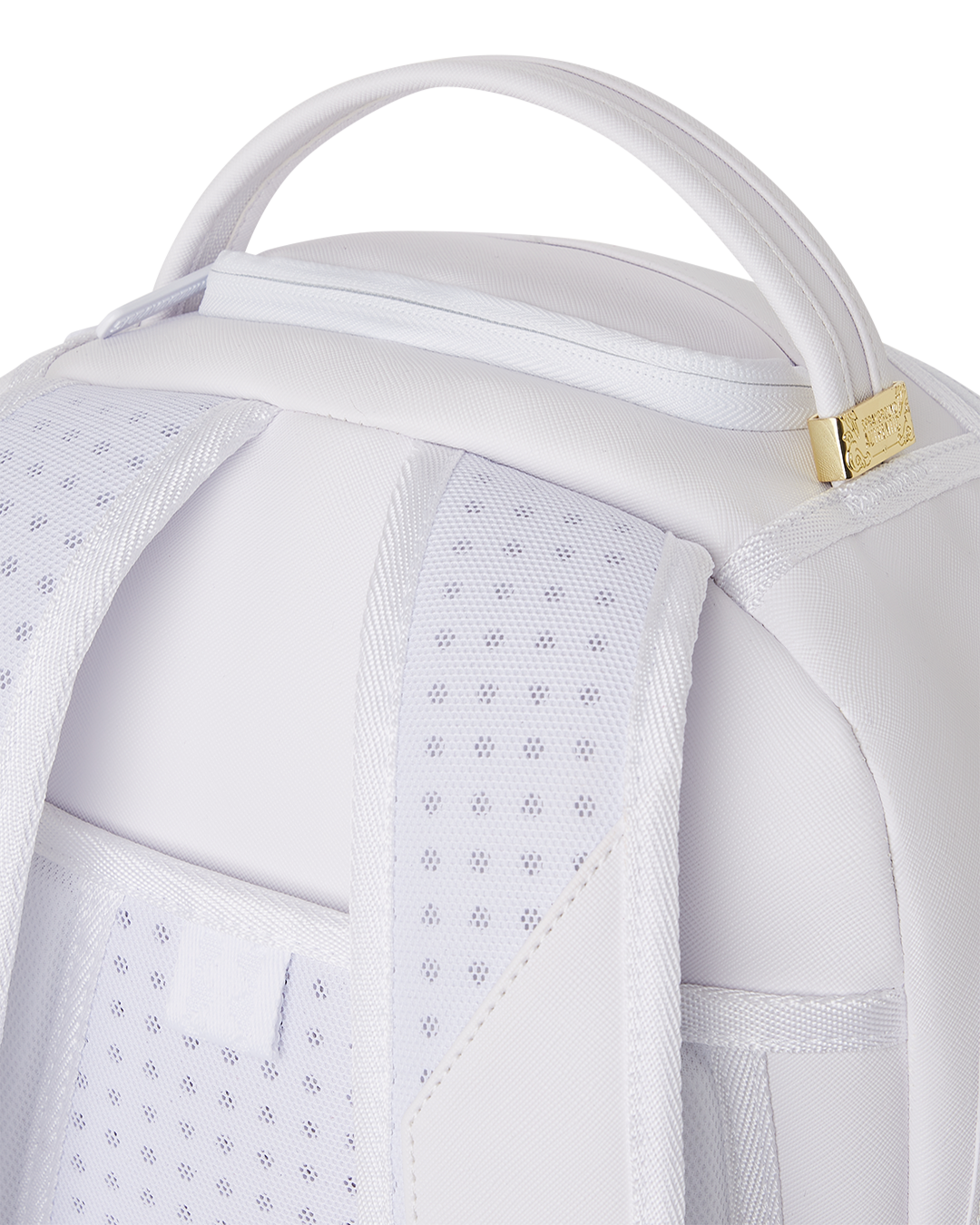 Luxury travel backpack mounted on carry-on luggage handle during airport transit