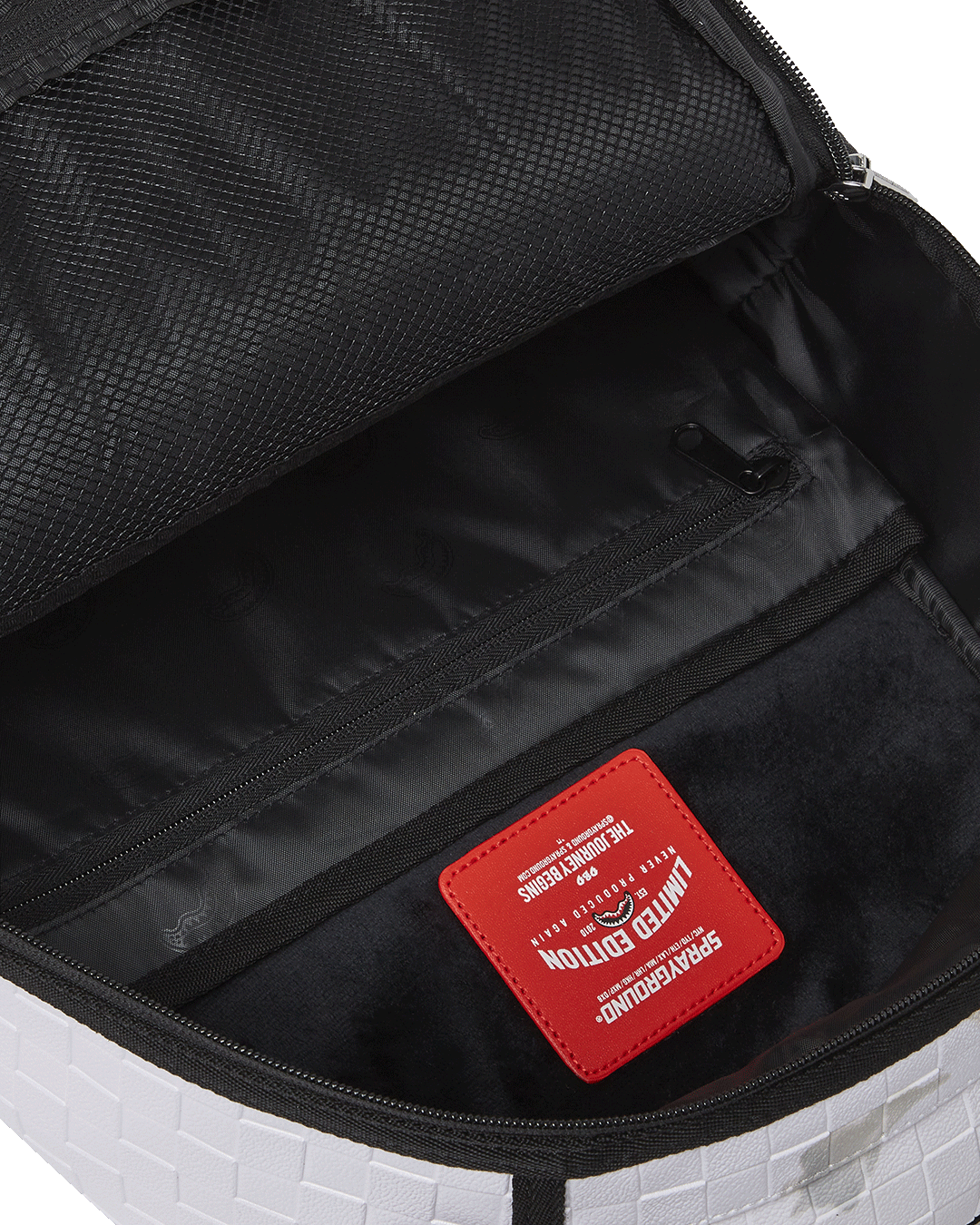 Travel-ready backpack with slide-through luggage sleeve and water-resistant exterior