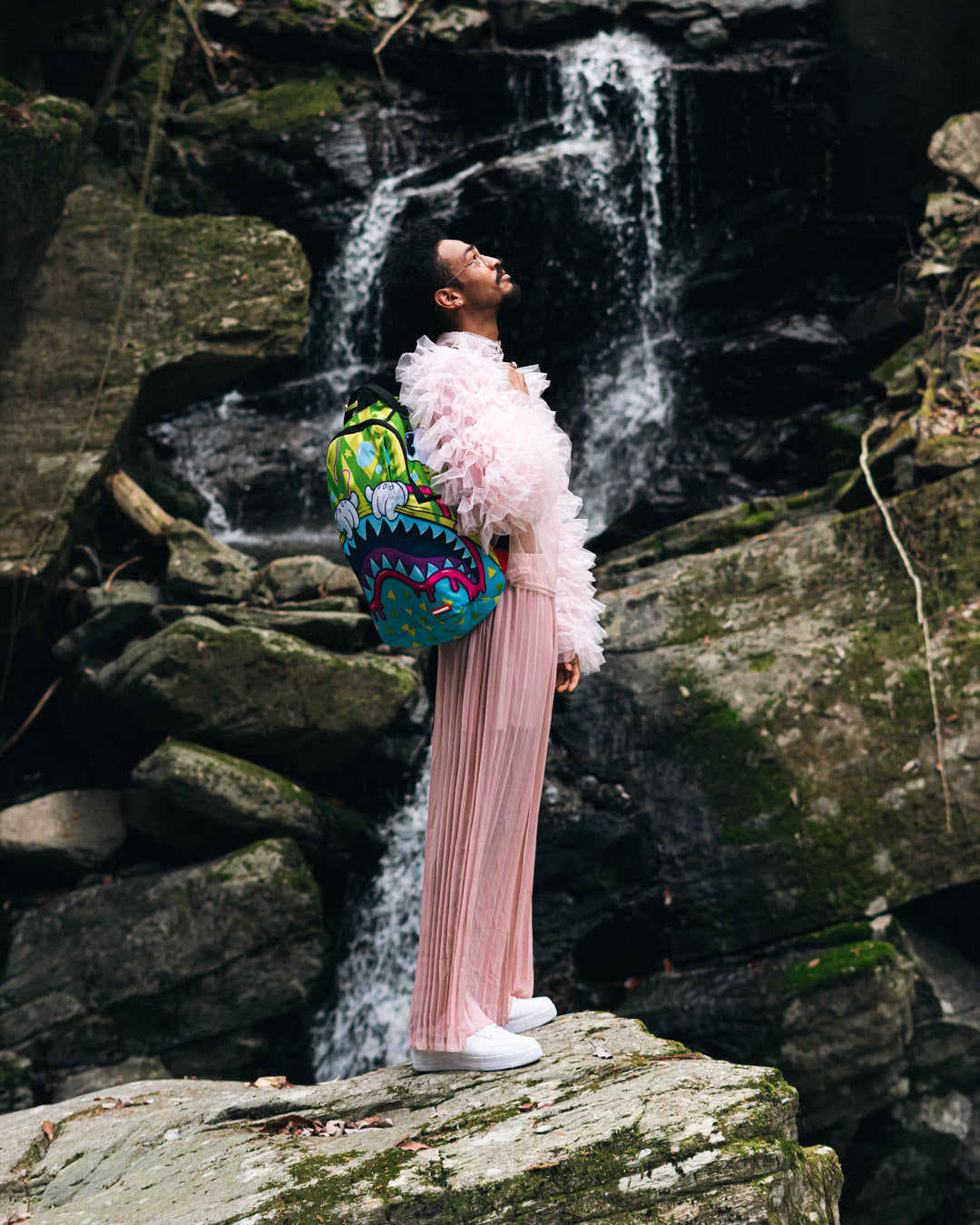 Side view featuring adjustable straps and gold hardware of the backpack.