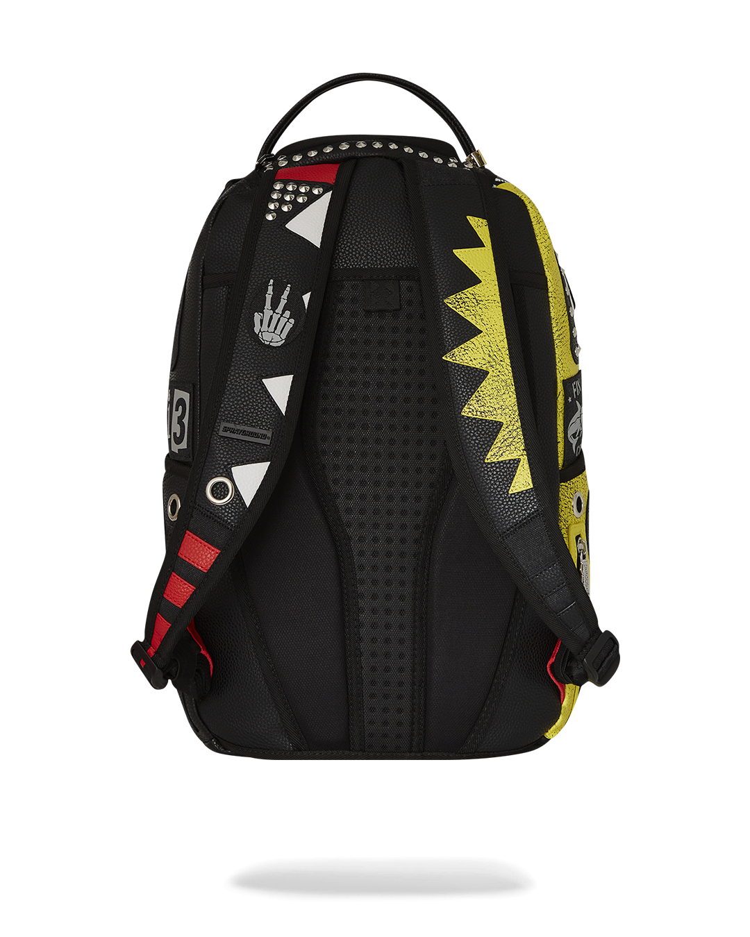 Soho Soundsystem leather backpack held against a brick wall, showcasing its urban aesthetic.