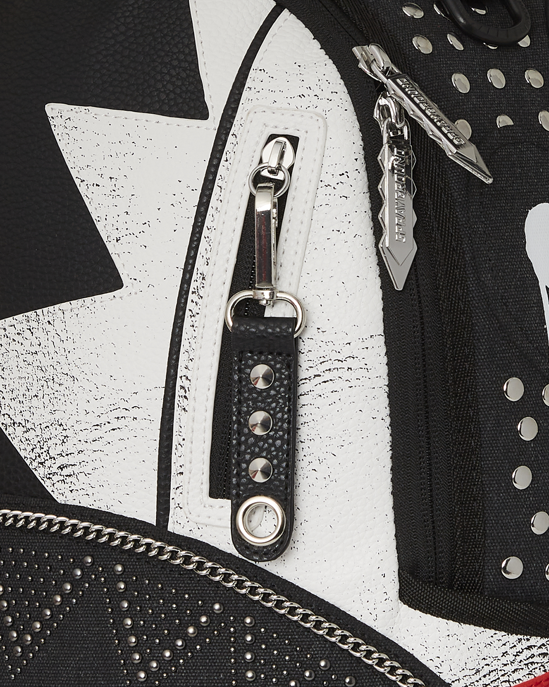 Soho Soundsystem leather backpack held against a brick wall, showcasing its urban aesthetic.