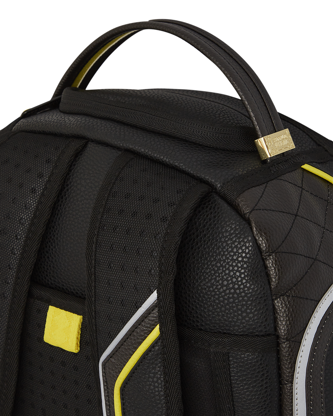 Close-up of the gold zippers and metal hardware on the faux leather backpack