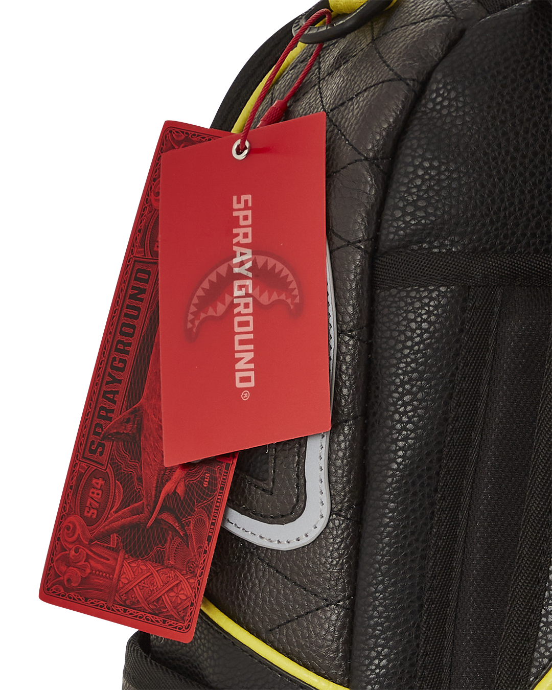 Close-up of the gold zippers and metal hardware on the faux leather backpack
