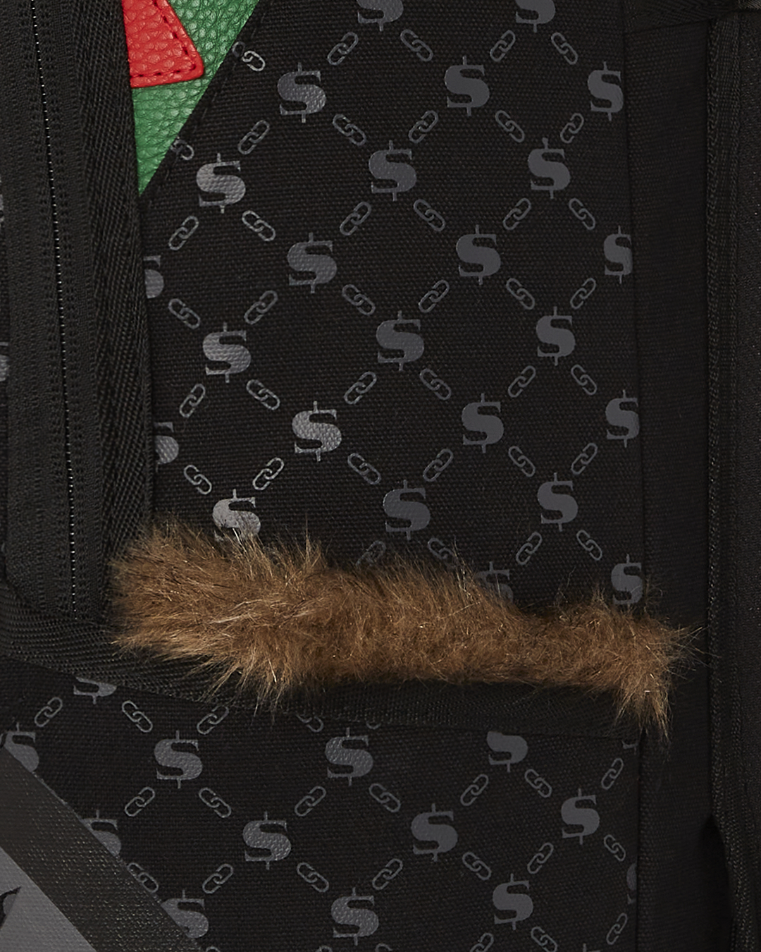 Side view of the faux leather backpack showing gold zippers and stash pocket