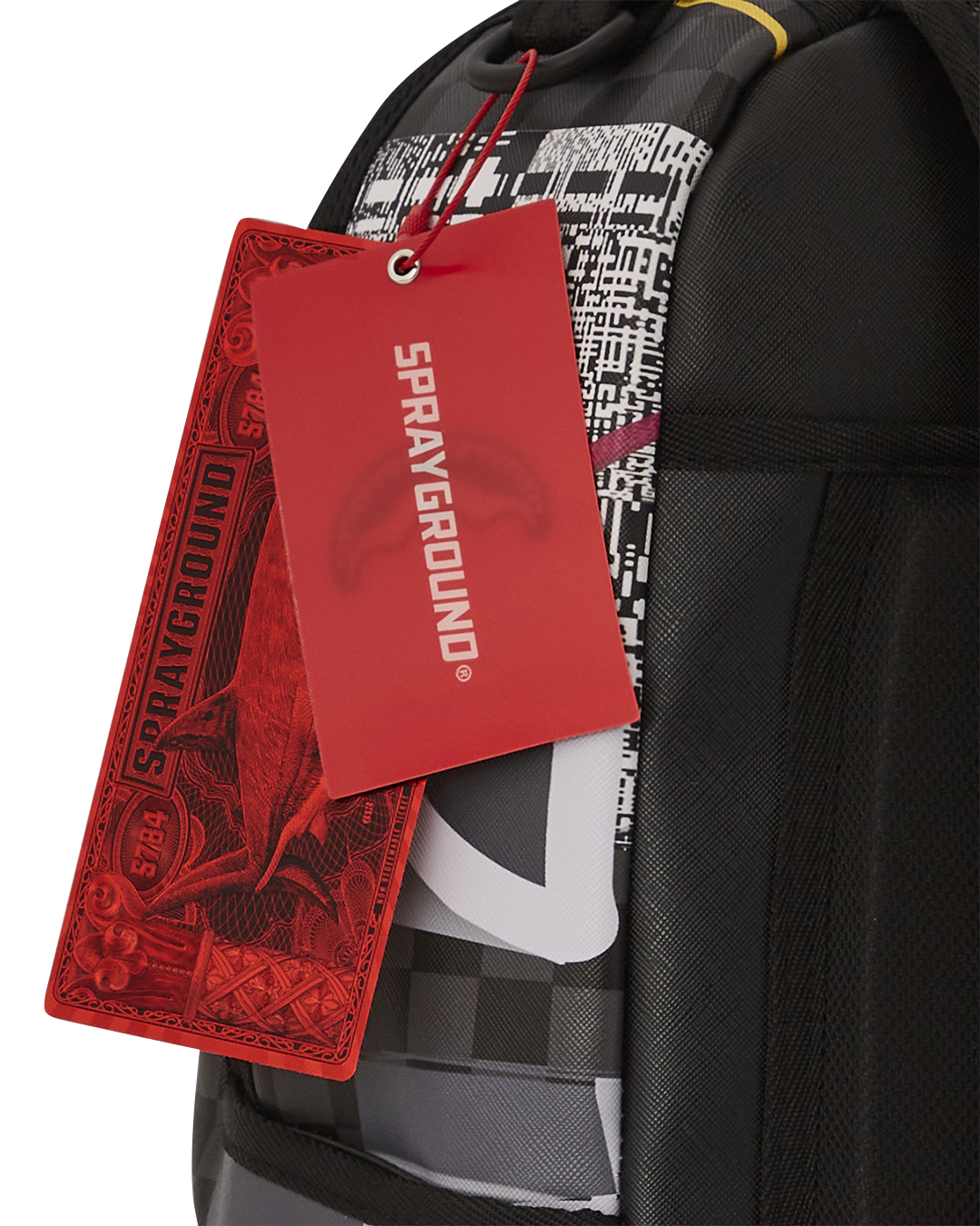 Close-up of Sprayground shark backpack’s gold zippers and textured faux leather