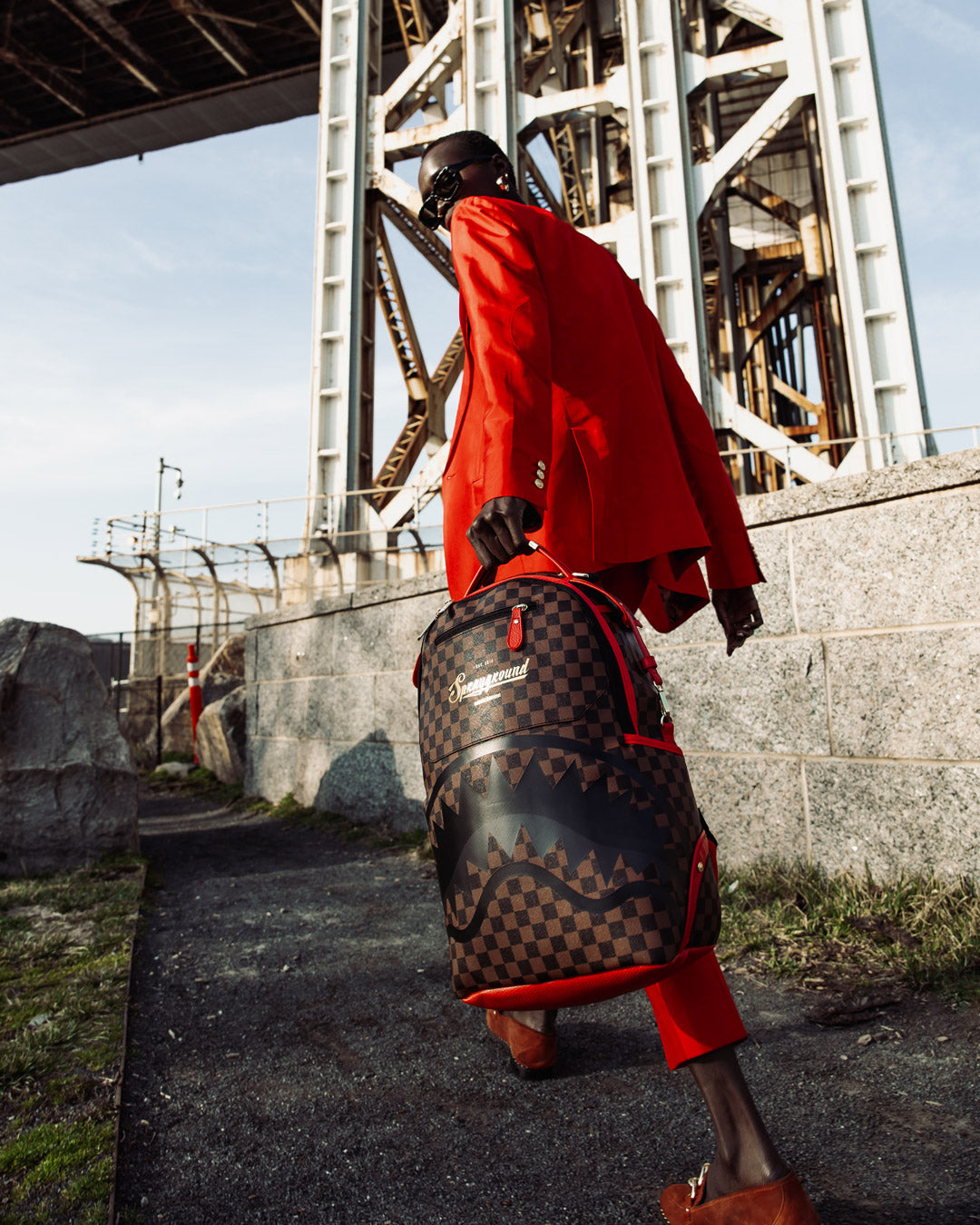 Backpack worn crossbody in a city setting, showcasing its sleek profile