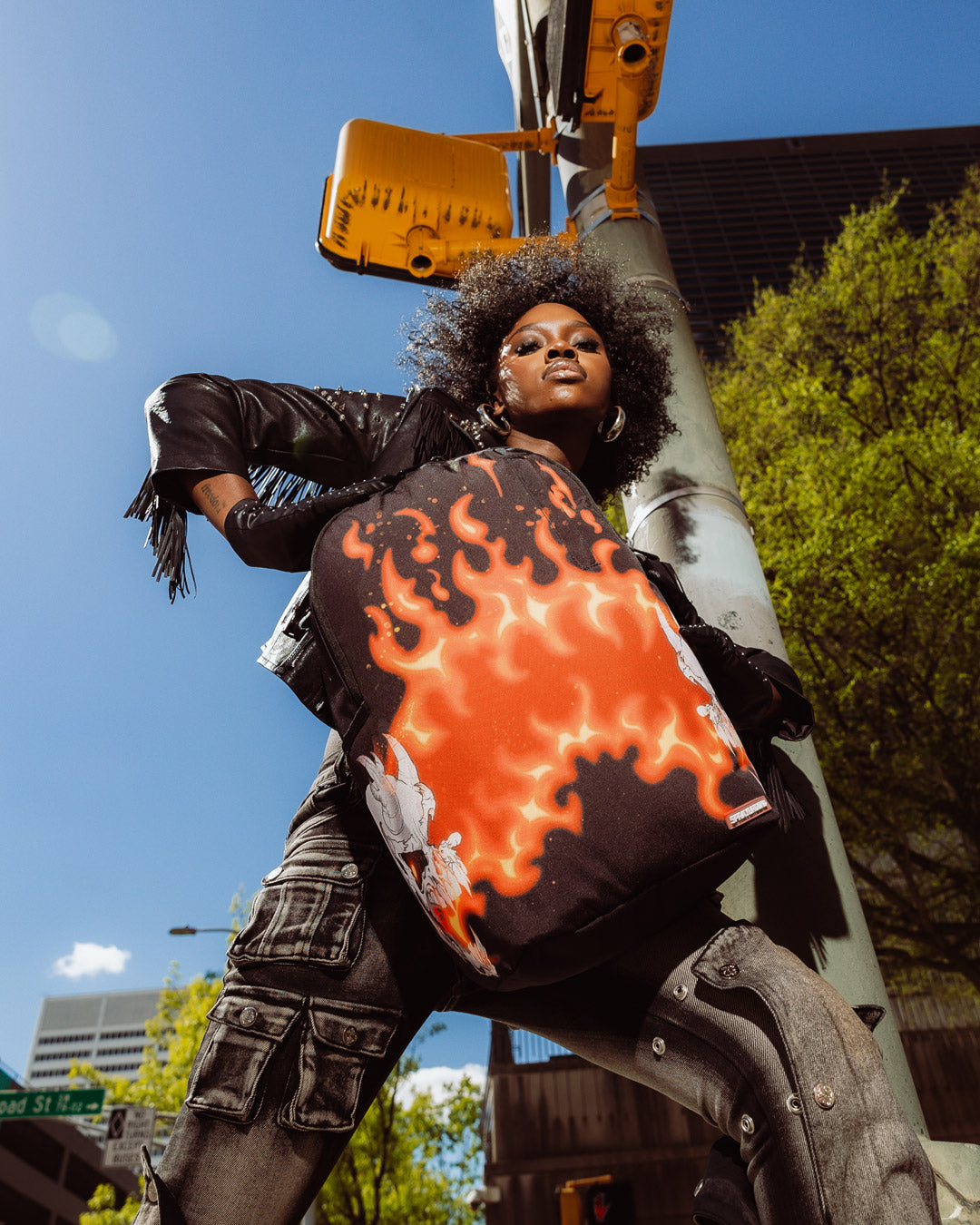 Sprayground Firestarter backpack open, showcasing laptop compartment and pockets