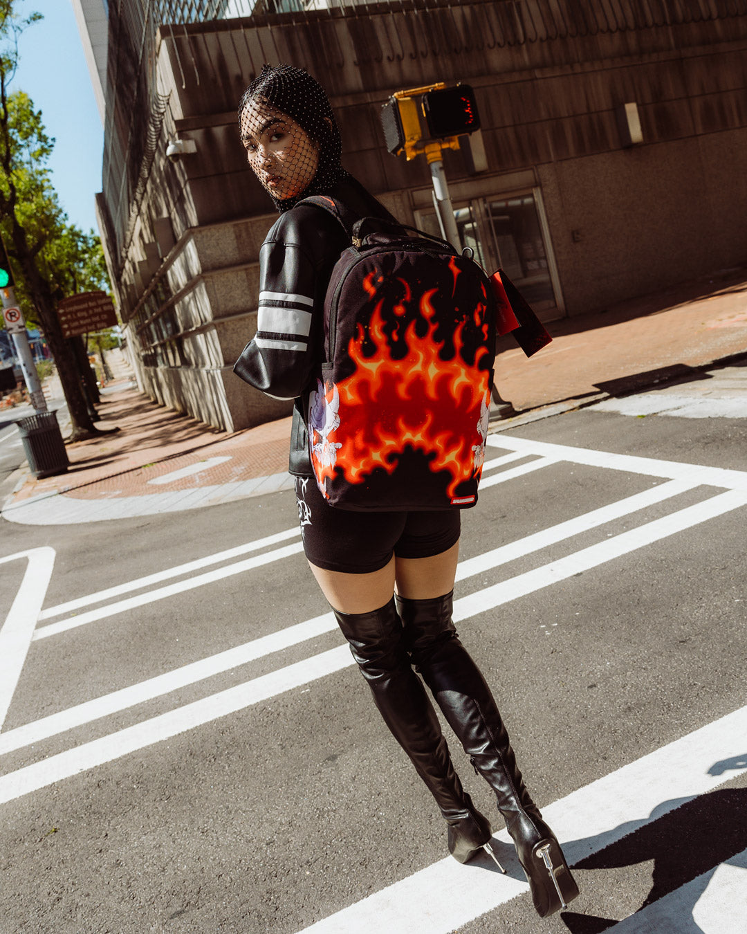 Woman wearing the Firestarter backpack in a city setting, side view