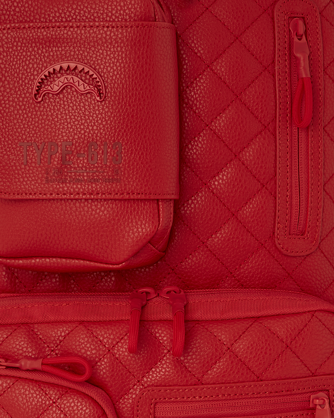 Side angle showing water-resistant faux leather backpack with luggage sleeve