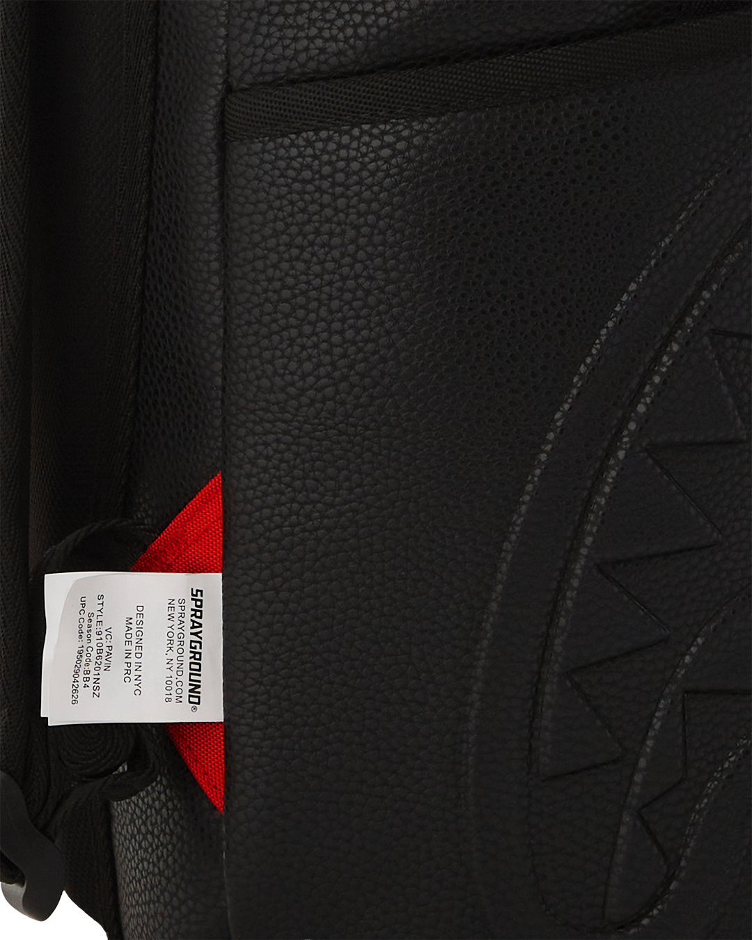 Side angle of laptop backpack for women attached to rolling luggage