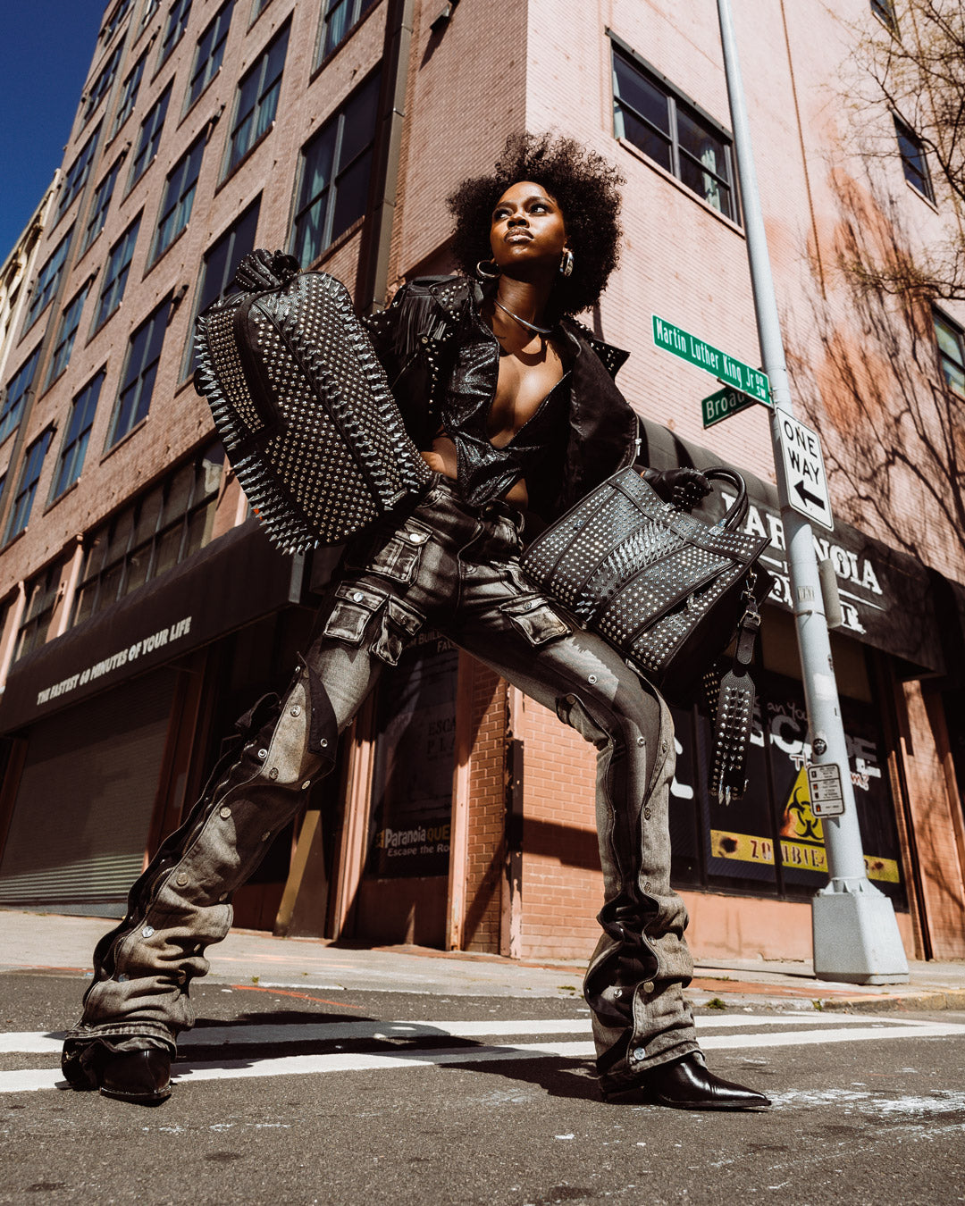 Front view of the pink Sprayground faux leather backpack with spikes.