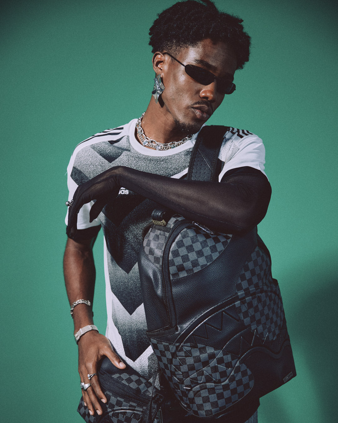 Ghost Wave backpack worn crossbody in a city setting, showcasing its compact profile