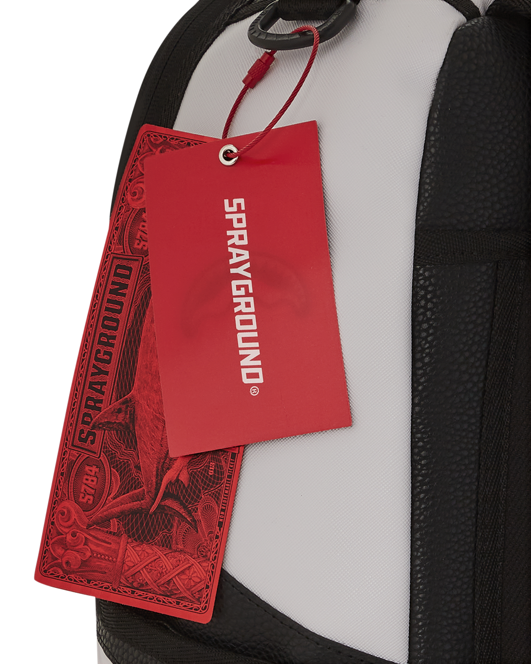 Front view of faux leather backpack showing gold zippers and badge