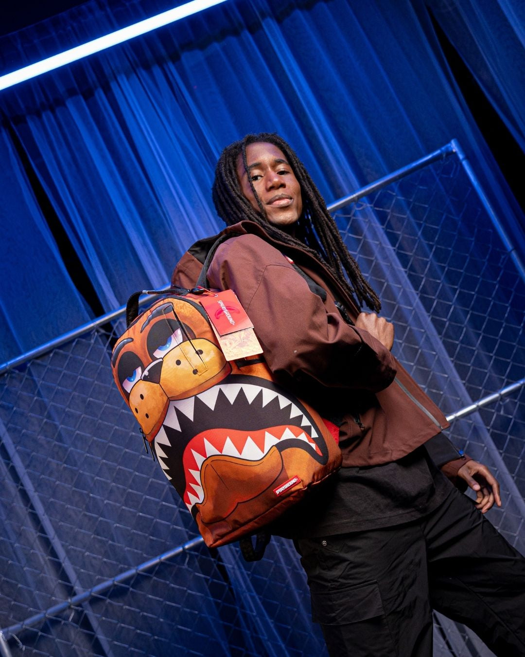 Sprayground Freddy Shark Backpack being used by a gamer at a desk