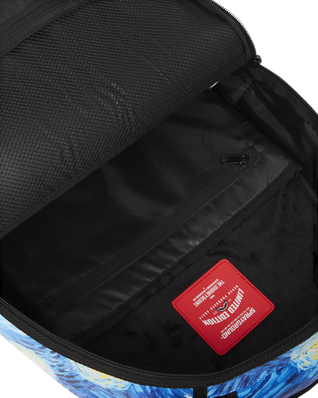 Interior view of the luxury faux leather backpack, featuring a separate velour laptop compartment.