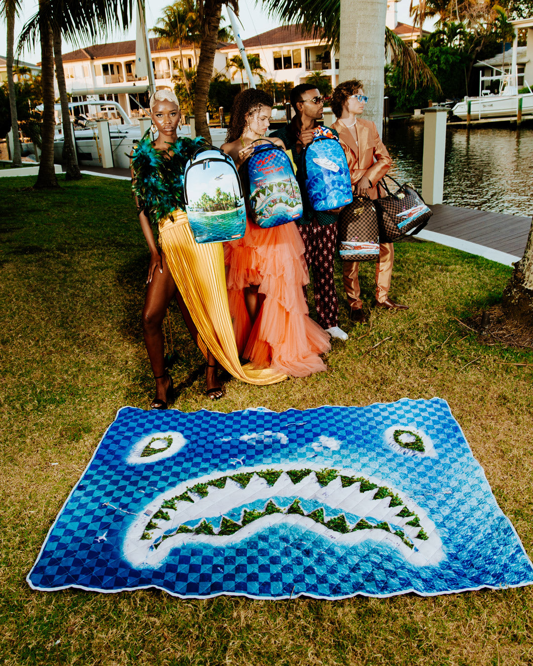 Coastal Cruiser convertible tote beach mat unfolded and spread out on the sand, with beach essentials on top.