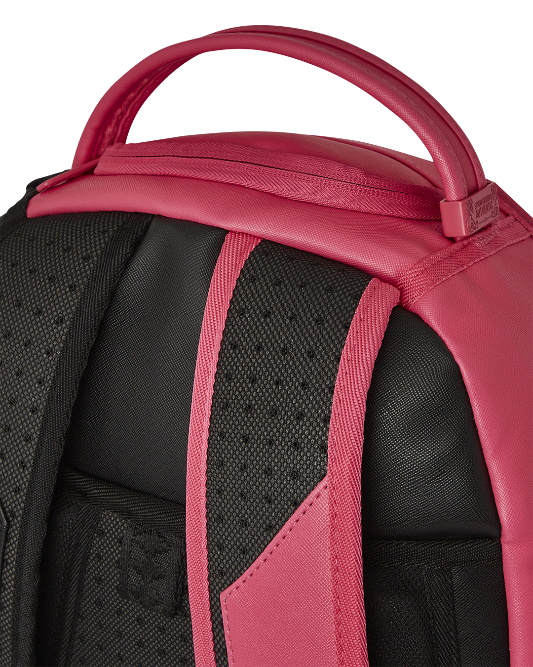 Close-up of the Shark Central Supernova backpack’s gold zippers and embossed logo